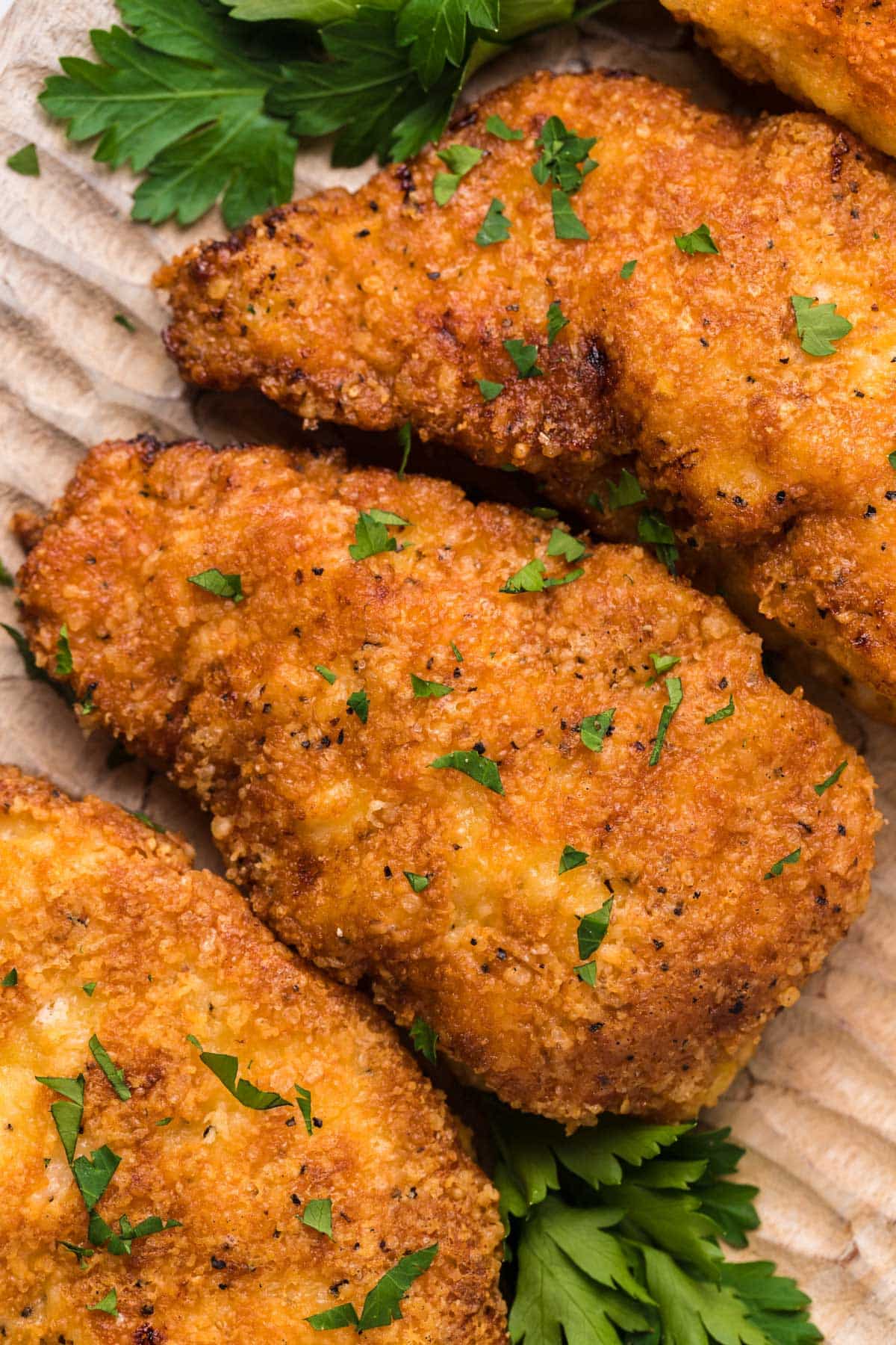 overhead view of a platter of romano crusted chicken