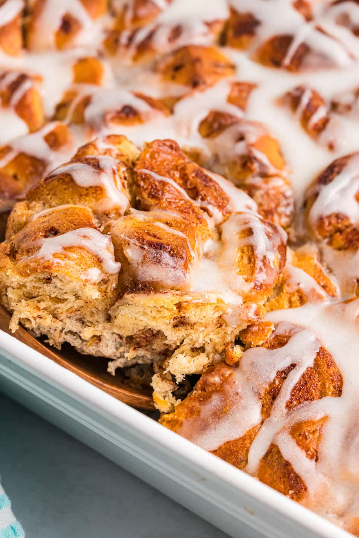 easy cinnamon roll casserole with glaze in a pan