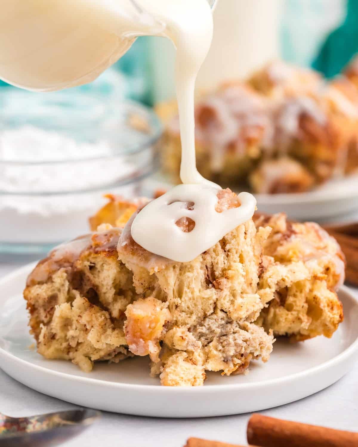 glaze pouring over cinnamon roll casserole