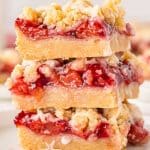 a stack of 3 cherry pie bars on a plate