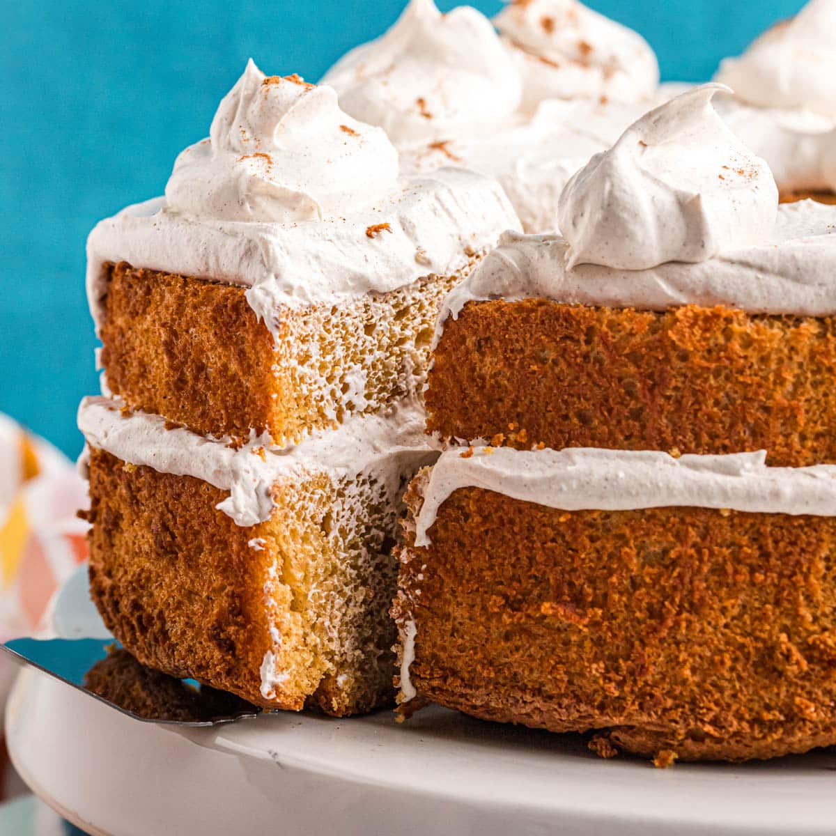 closeup of a two layer pumpkin angel food cake with one slice cut