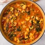 overhead view of a pot of sausage tortellini soup with kale