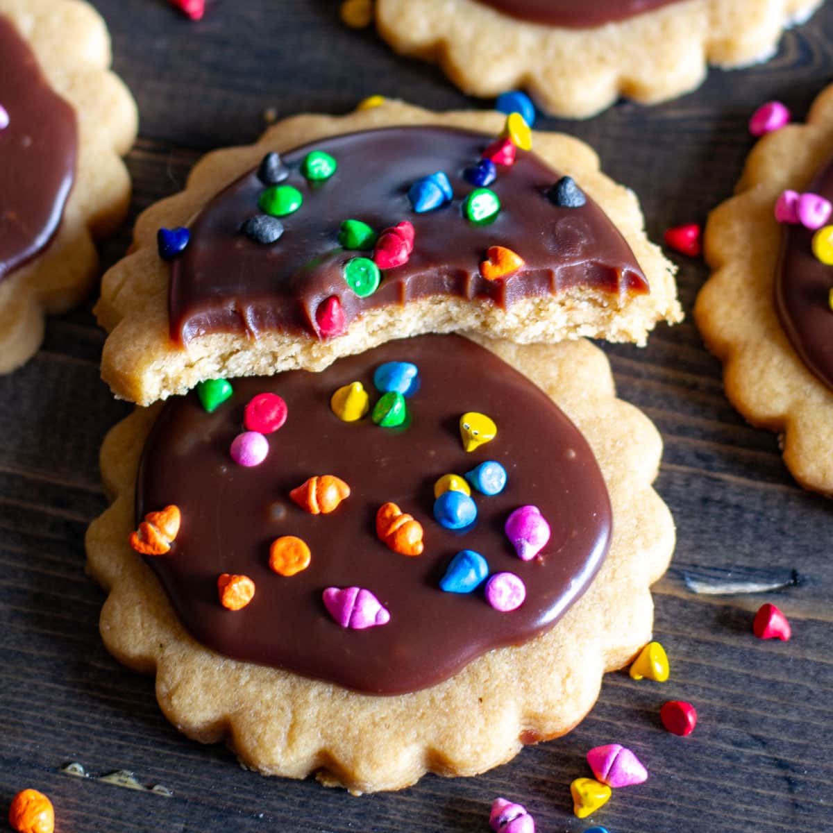 two peanut butter cut out cookies with ganache on top