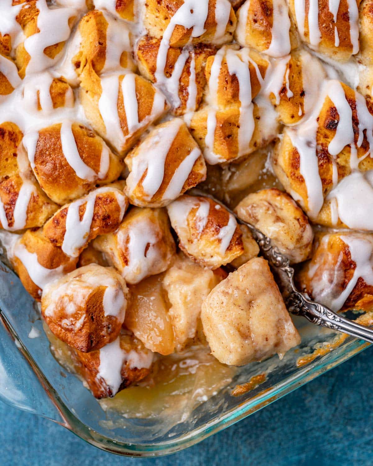cinnamon rolls with apple pie filling in a dish with a spoon