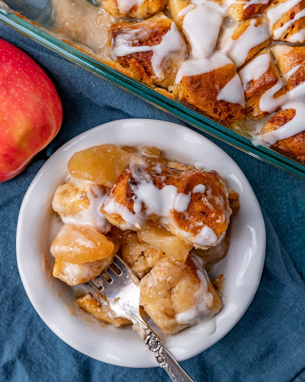 a bowl of cinnamon rolls and apple pie filling on a table