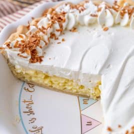 coconut cream pie in a pan with two slices missing
