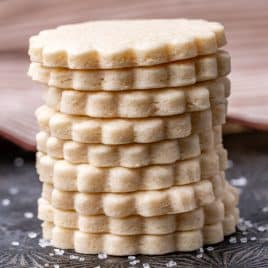 a stack of cream cheese sugar cookies on a pan
