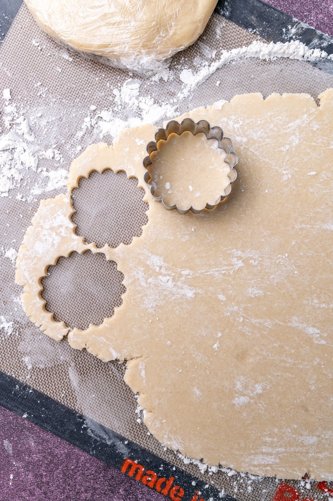 sugar cookie dough rolled out with a cookie cutter cut out