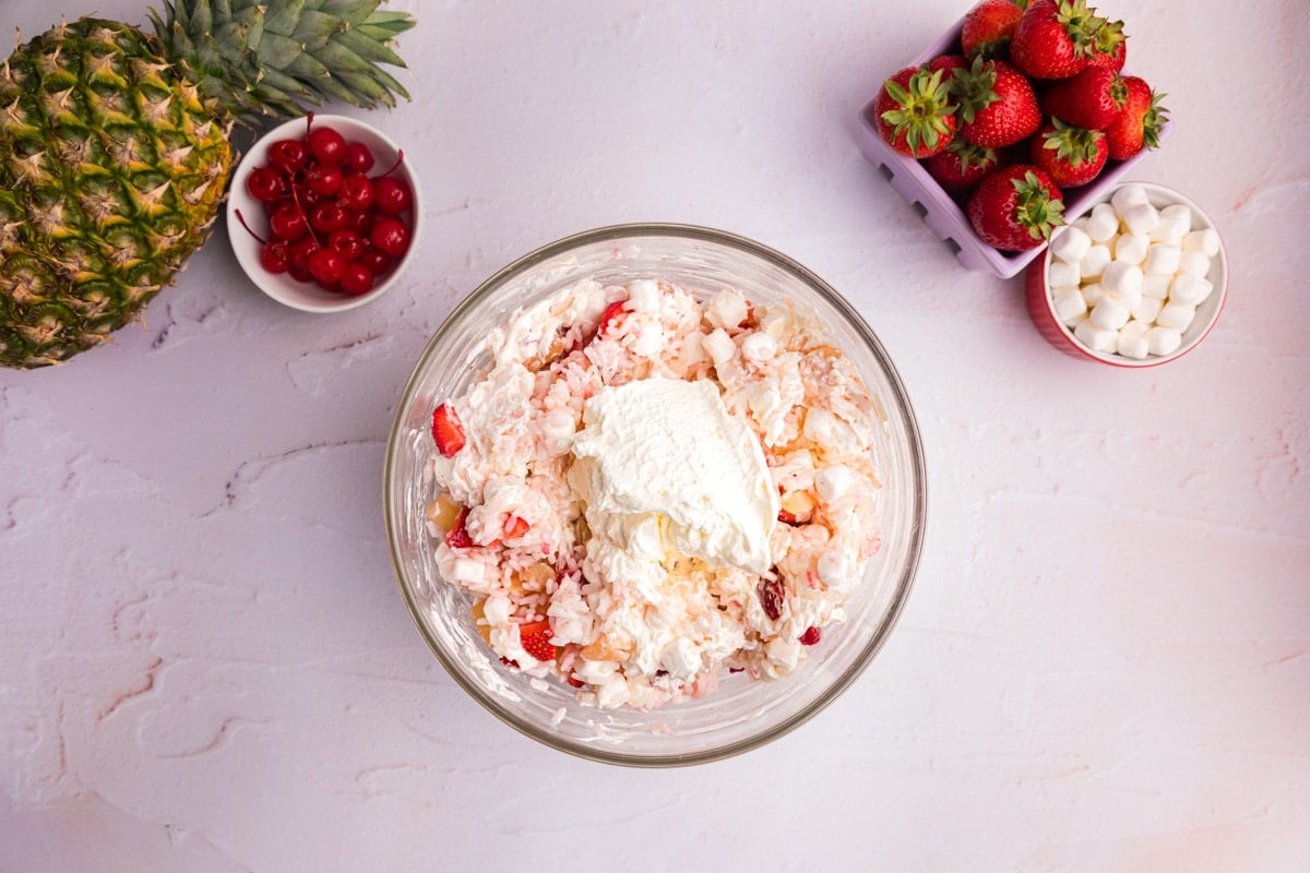 glorified rice in a bowl with whipped cream on top