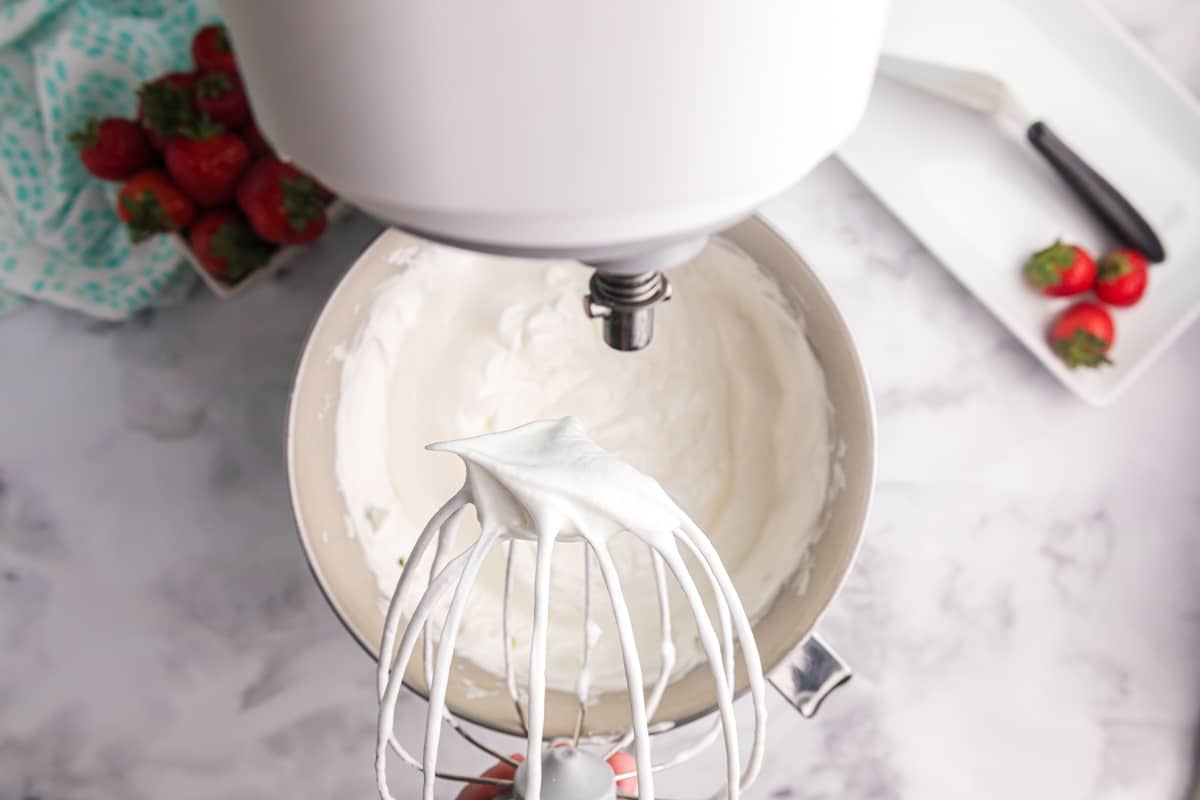 whipped egg whites holding peaks on a wire whisk