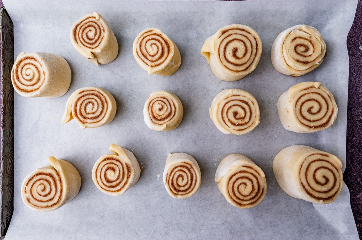 unbaked cinnamon rolls on a baking sheet