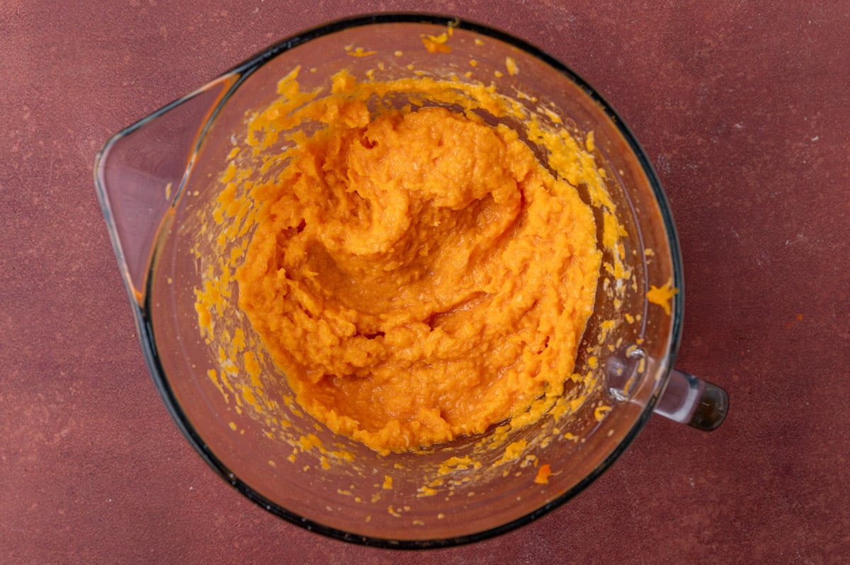 mashed butternut squash in a glass mixing bowl