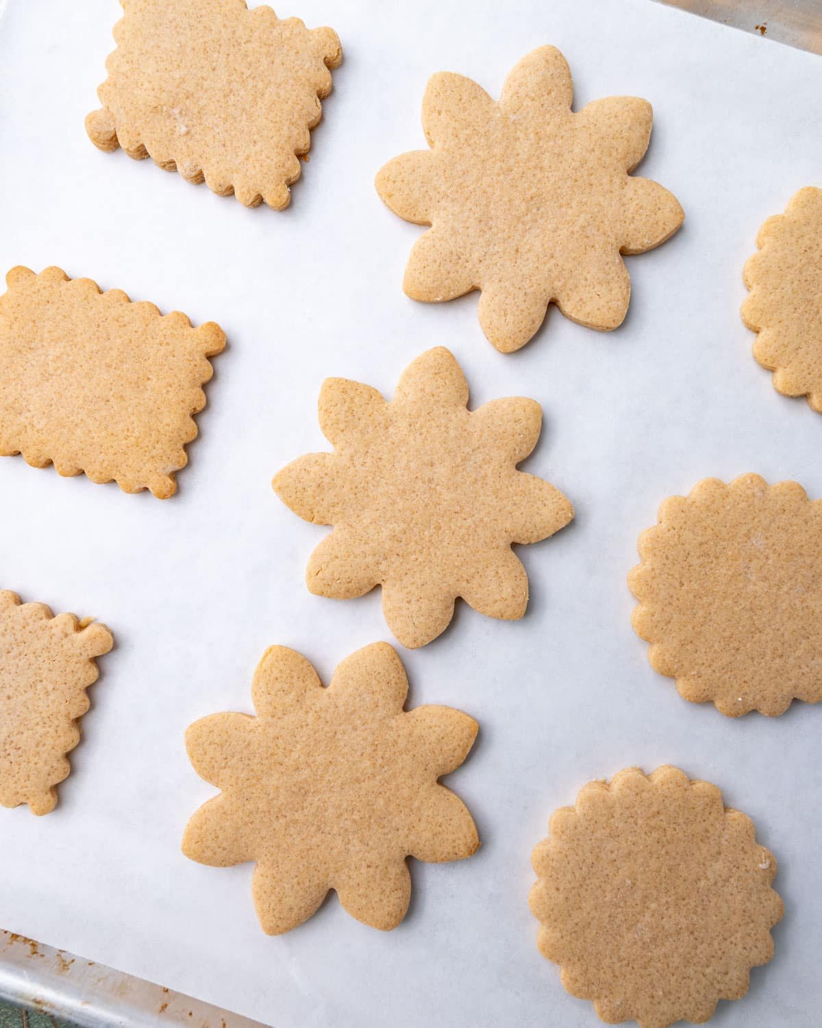 baked peanut butter cut out cookies on a baking sheet