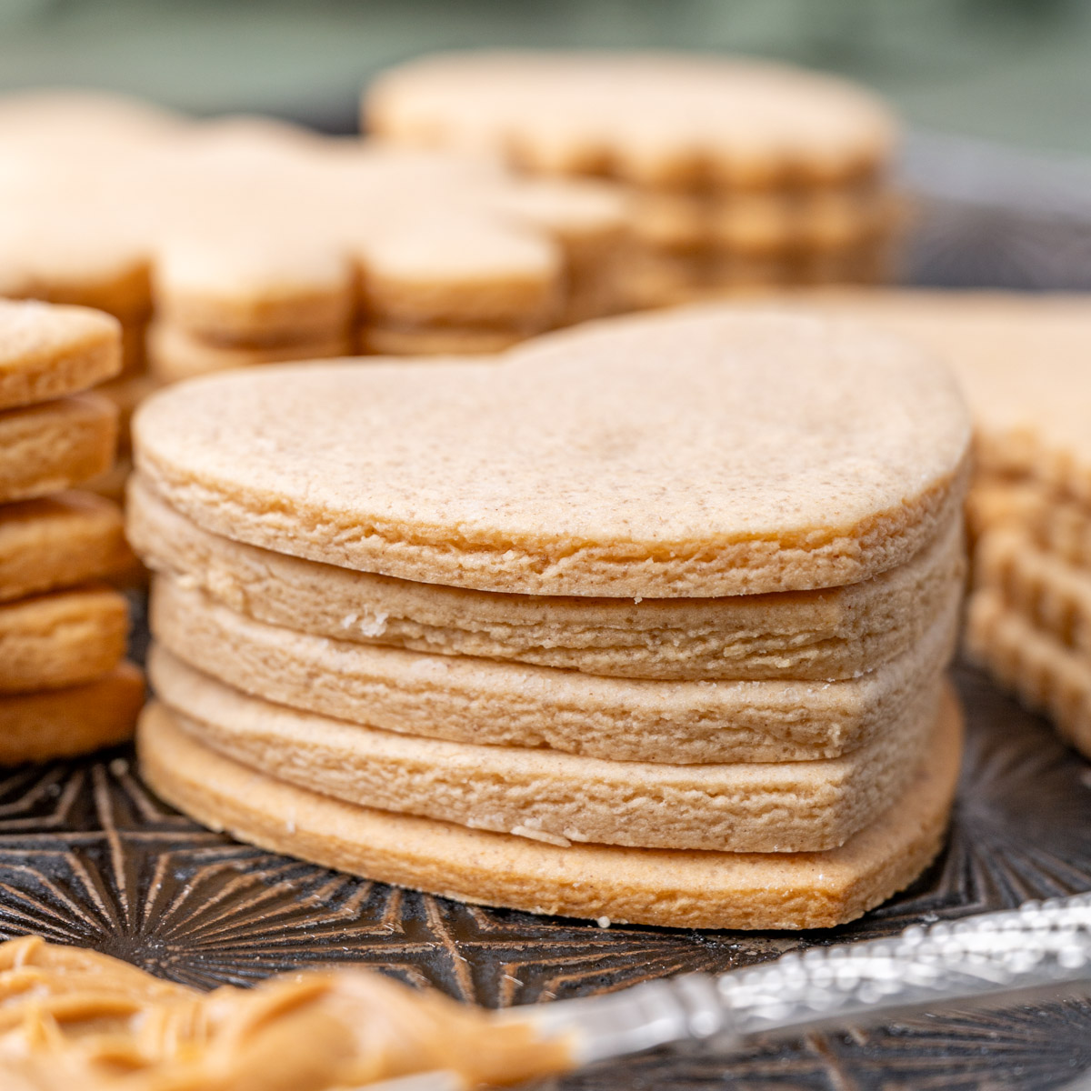 a stack of heart shaped peanut butter cookies