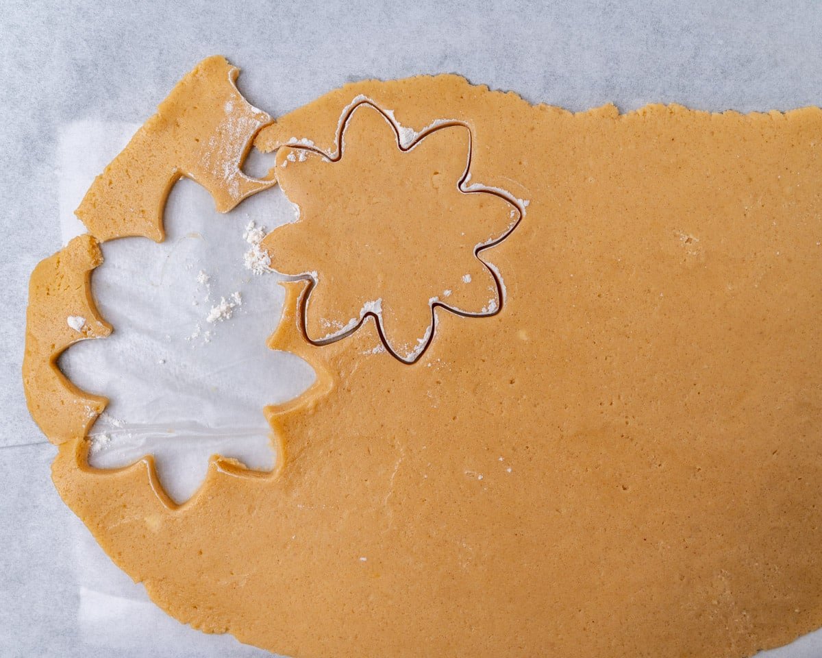 rolled peanut butter cut out cookie dough on parchment paper