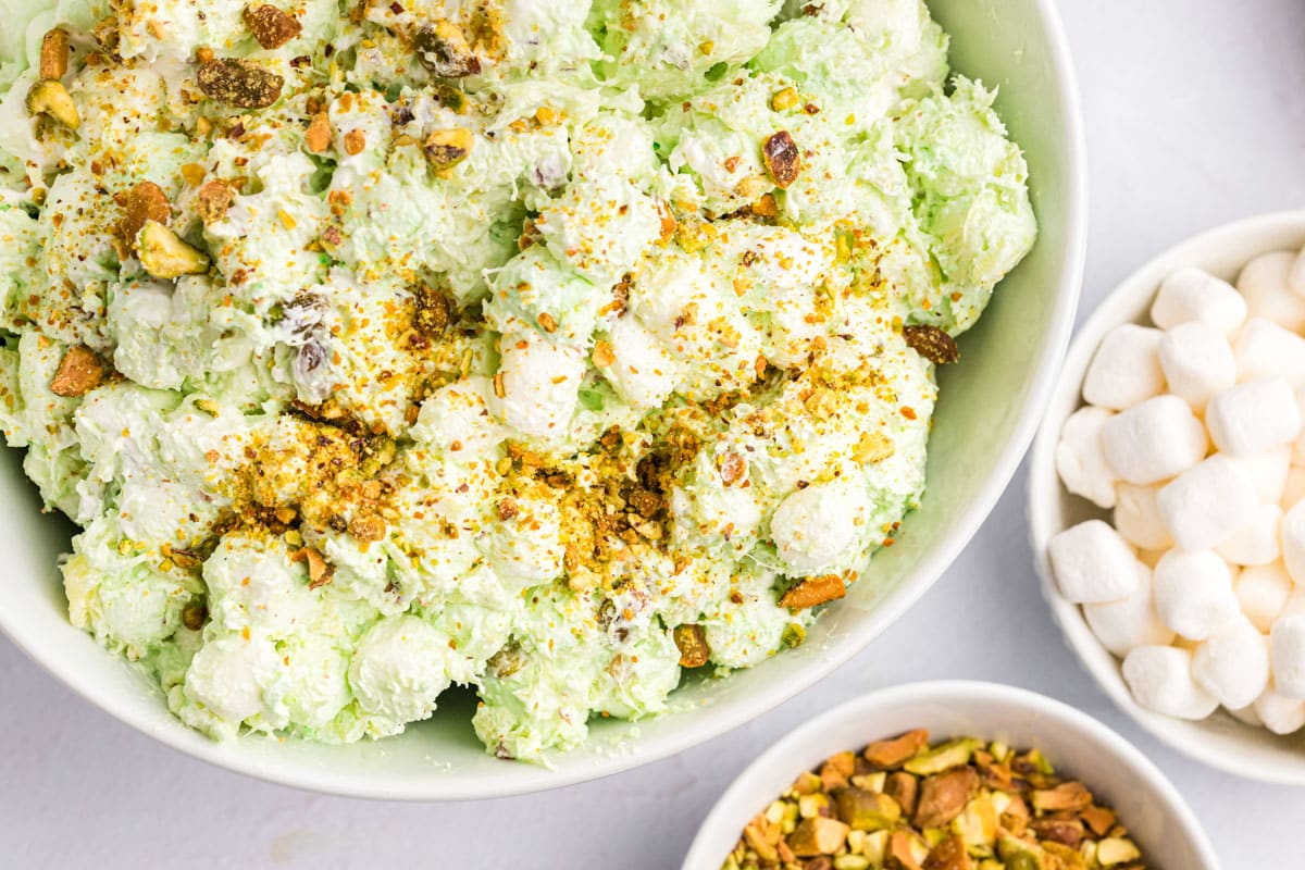 pistachio fluff salad in a bowl with crushed pistachios on top