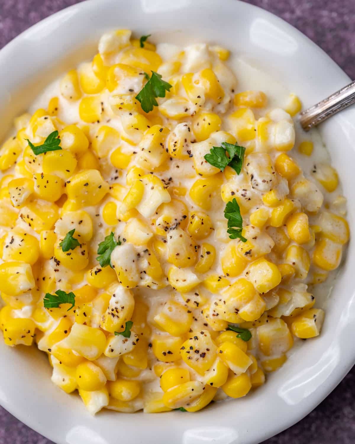 creamed corn in a bowl with a spoon