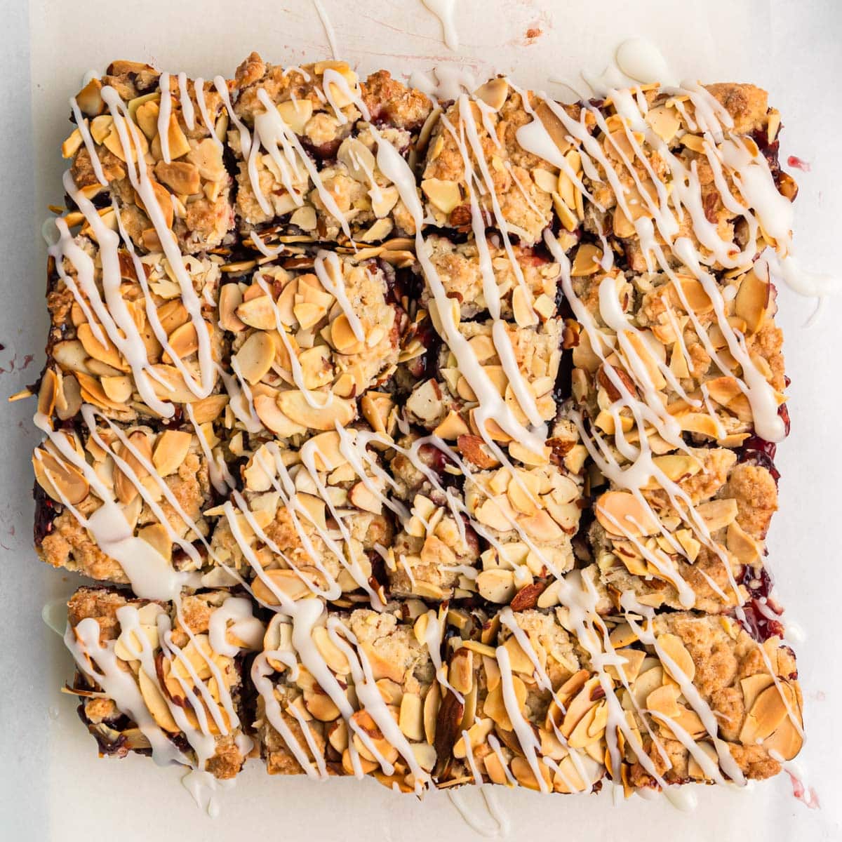 overhead view of glazed almond raspberry bars cut into squares