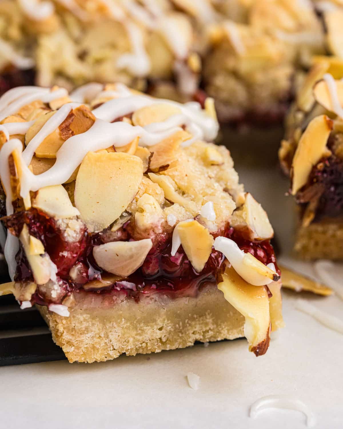 closeup of an almond raspberry bar on a table