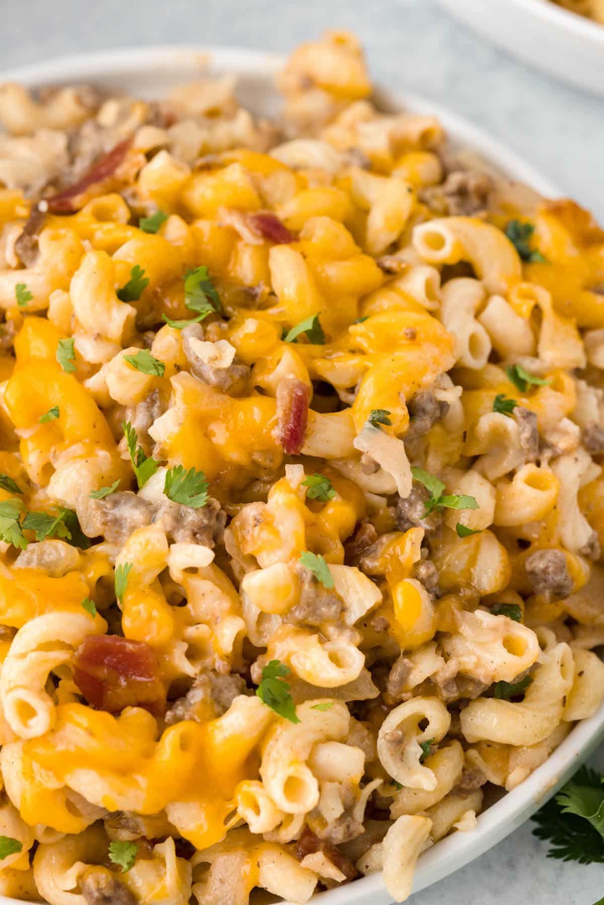 a bowl of bacon cheeseburger casserole with parsley on top