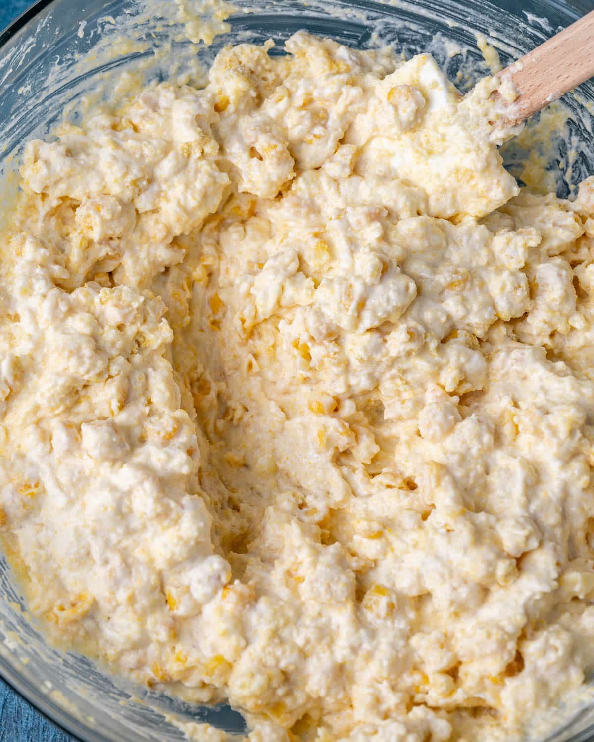 corn casserole batter mixed in a bowl with a spatula