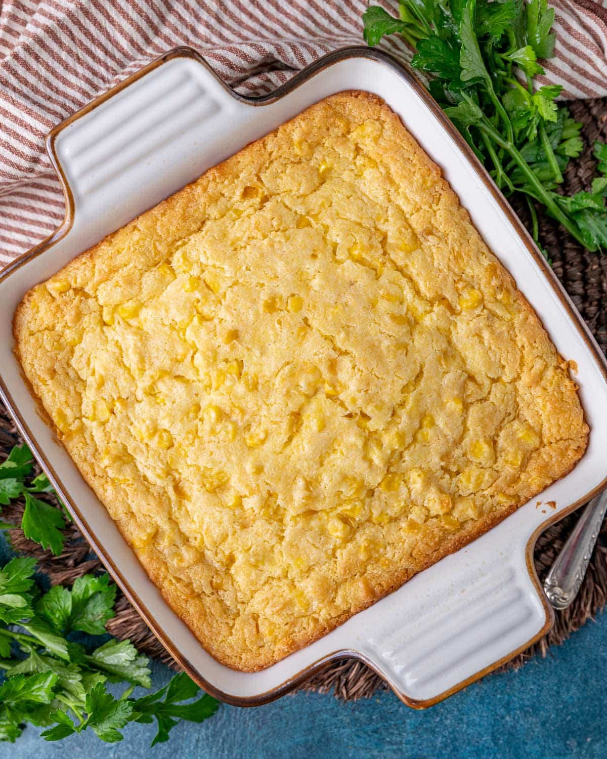 baked corn casserole in a white dish