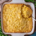 corn casserole in a baking pan with a spoon