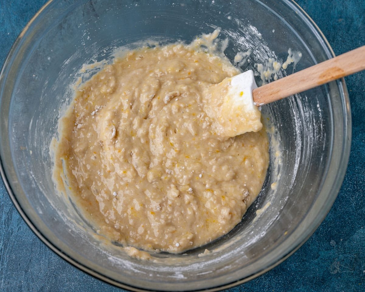 quick bread batter in a glass bowl with a spatula