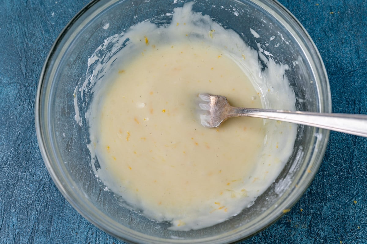 orange glaze in a bowl with a fork