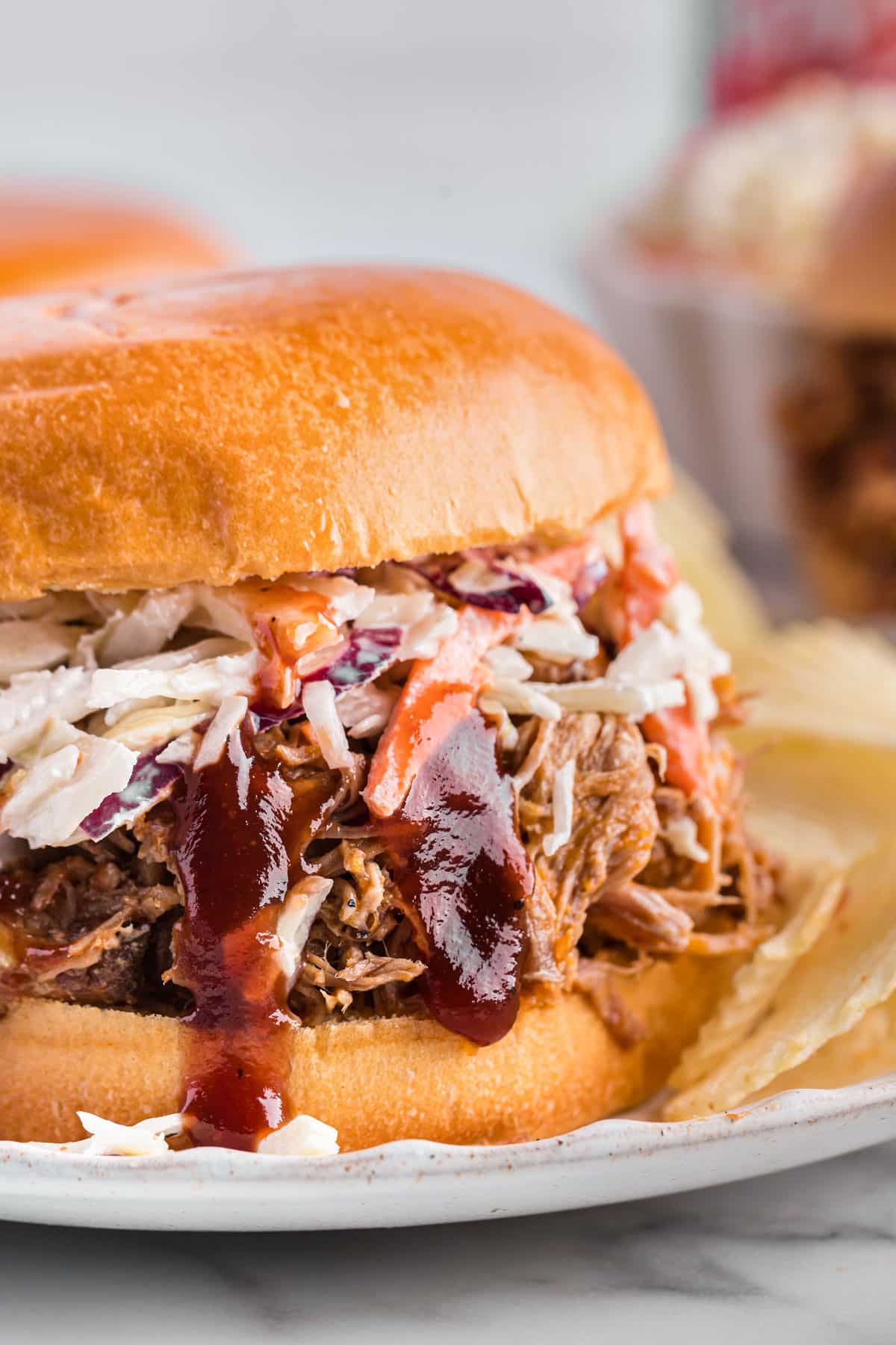 a pulled pork sandwich with bbq sauce and coleslaw