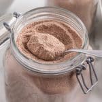 homemade hot chocolate mix in a glass jar with a spoon