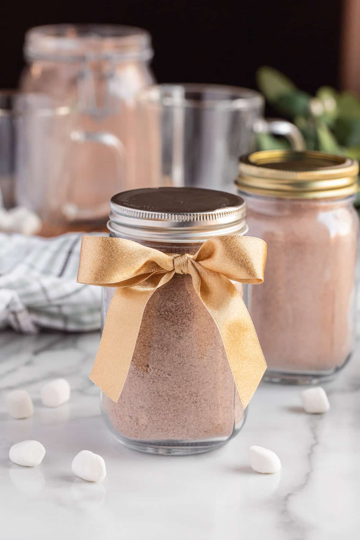 hot chocolate mix in a mason jar with a ribbon