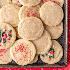 overhead view of sugar cookies wtih christmas sprinkles on a plate