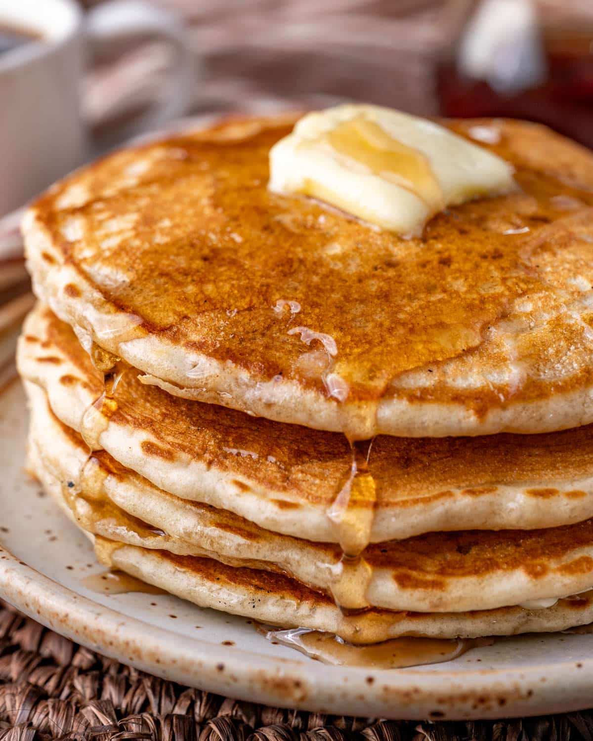 a plate of sourdough pancakes with dripping syrup