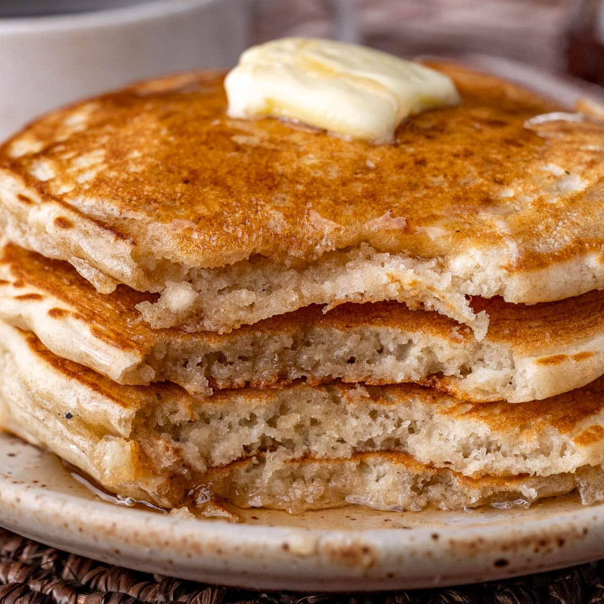 closeup of a stack of pancakes with a bite out