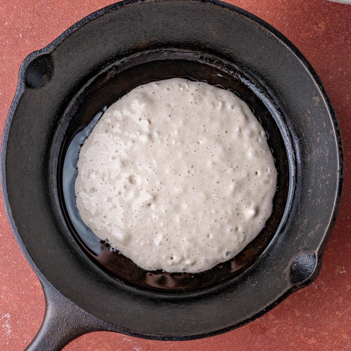 pancake cooking in a cast iron skillet