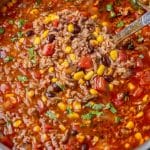mexican soup with ground beef and rice in a pot