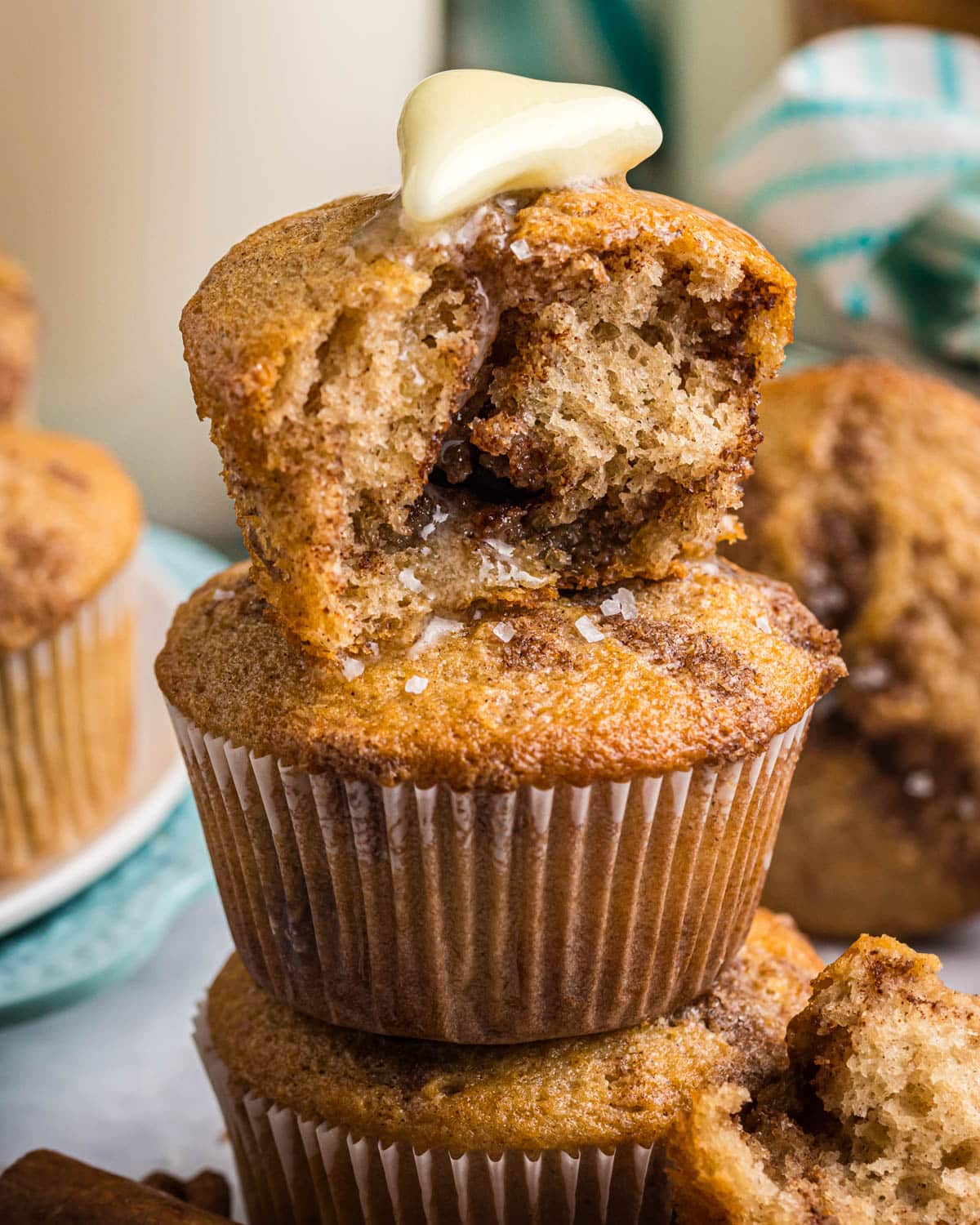 a stack of cinnamon buttermilk muffins, with one broken in half on top