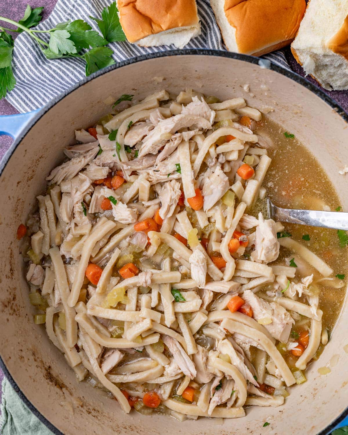 a pot of homemade chicken noodle soup with egg noodles