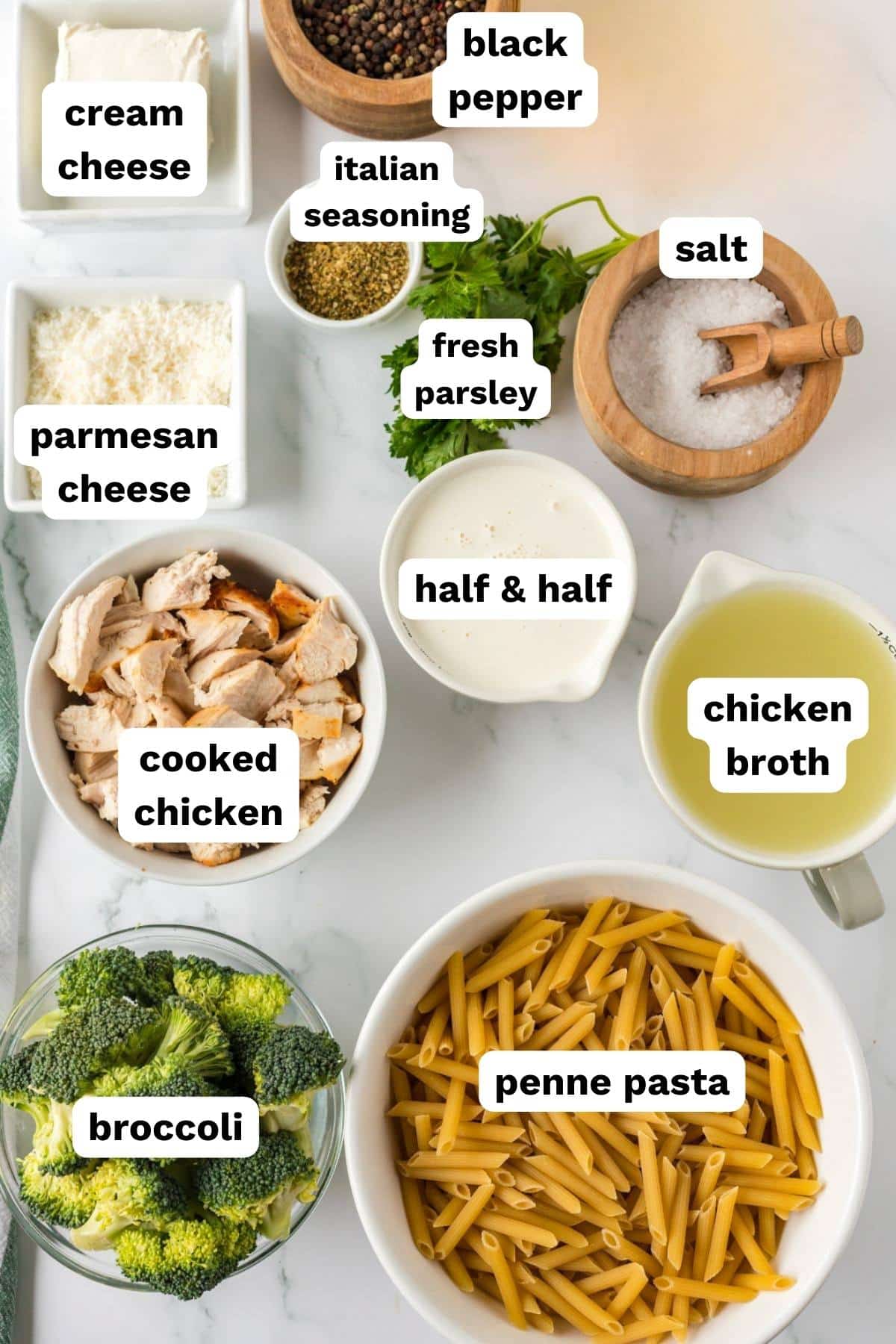 ingredients for chicken and broccoli pasta on a table