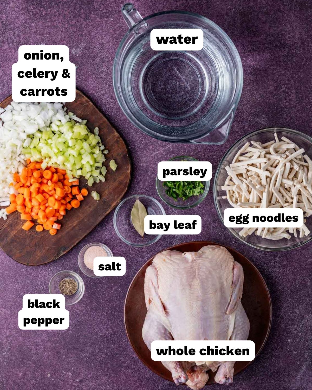 ingredients for homemade chicken noodle soup on a table