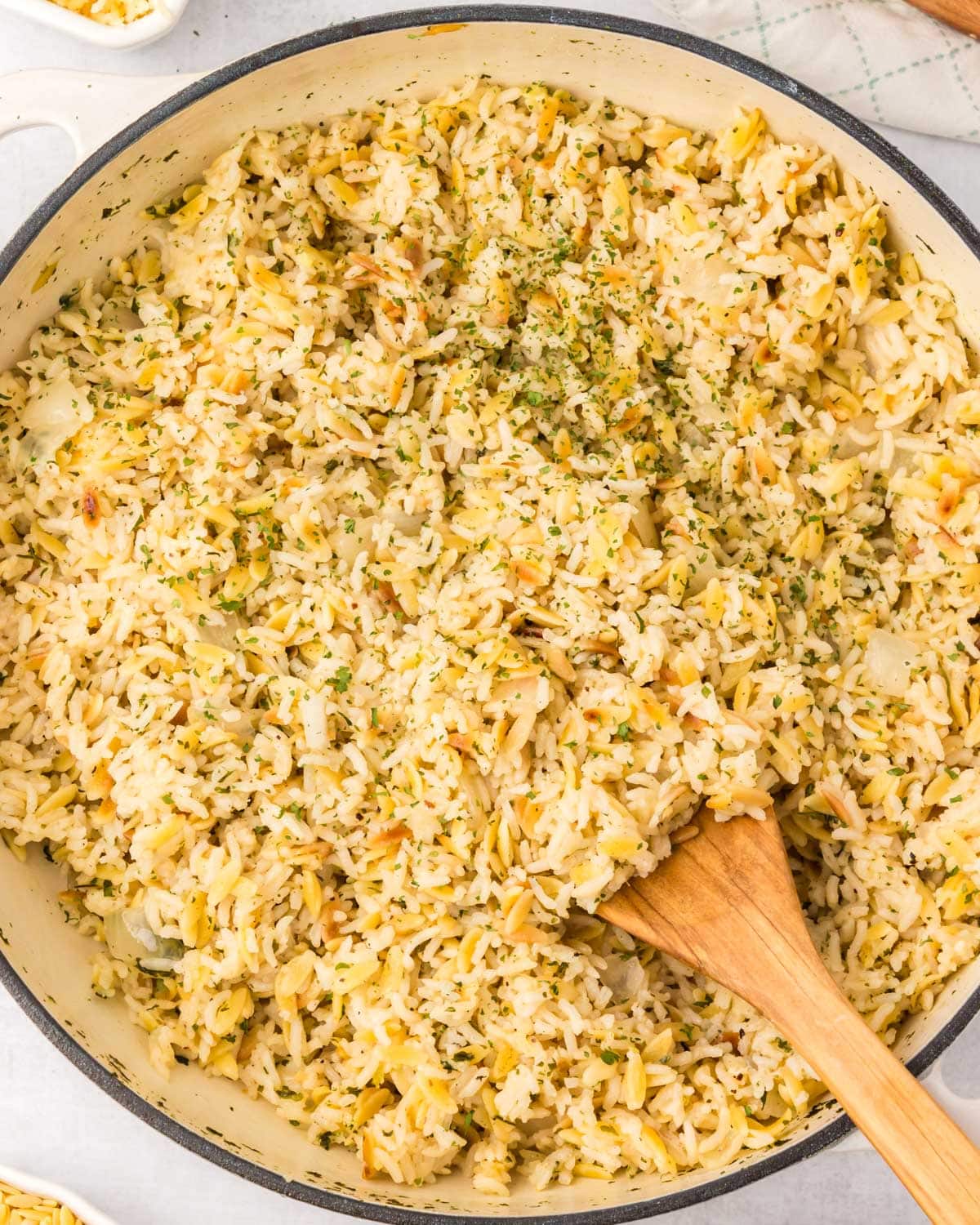 overhead view of orzo rice pilaf in a skillet