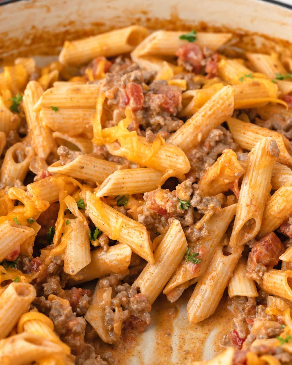 rotel pasta with cheddar cheese in a skillet