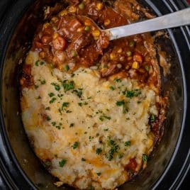 overhead view of slow cooker shepherds pie with a spoon