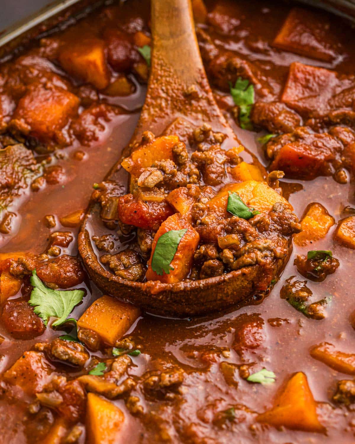 a wooden ladle full of sweet potato chili