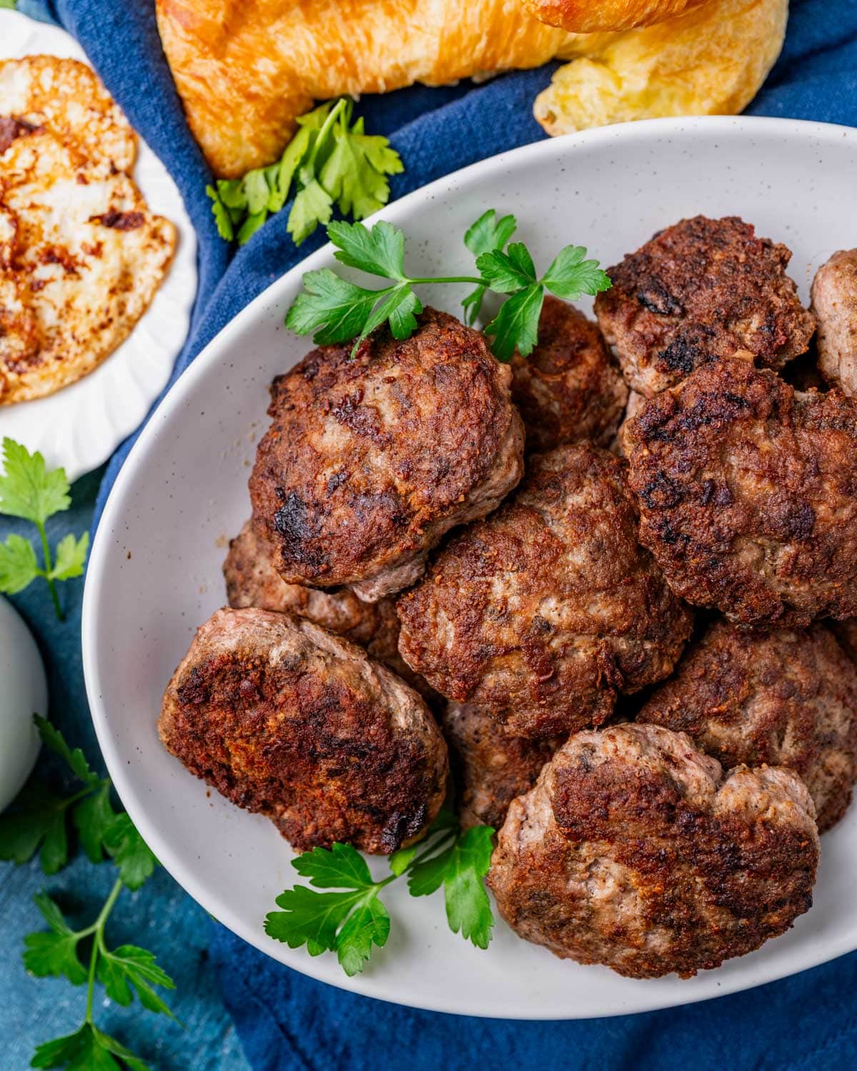 overhead view of turkey sausage with croissants and eggs