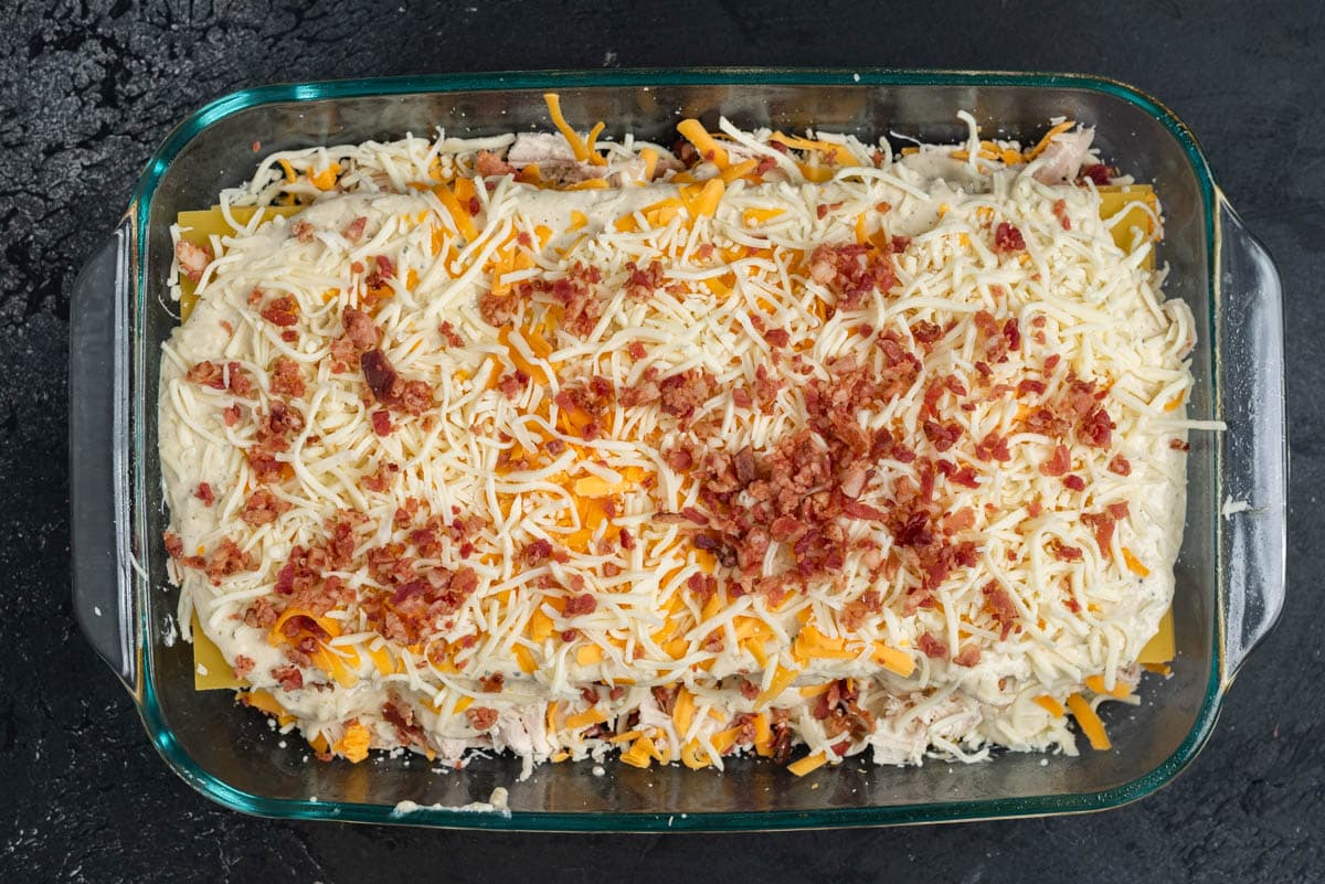 unbaked chicken bacon lasagna in a glass pan