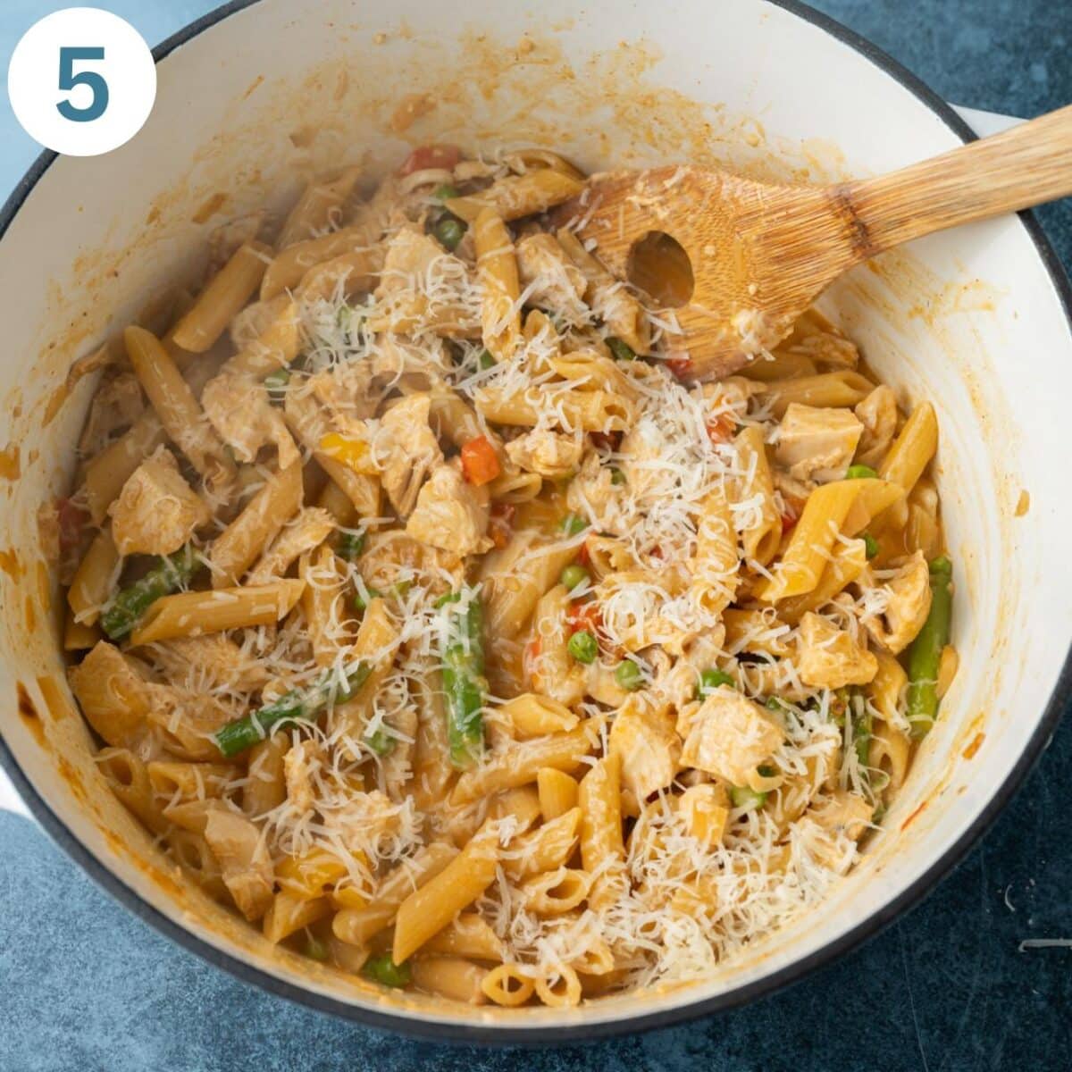a pot of spicy chipotle chicken pasta with parmesan cheese on top