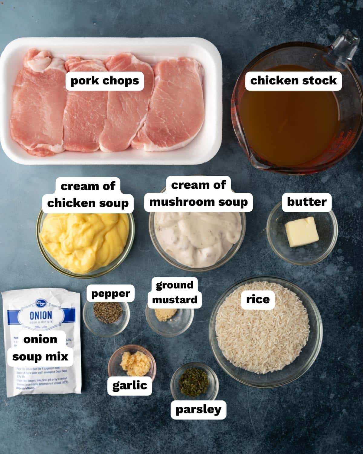 ingredients for pork chops and rice on a table