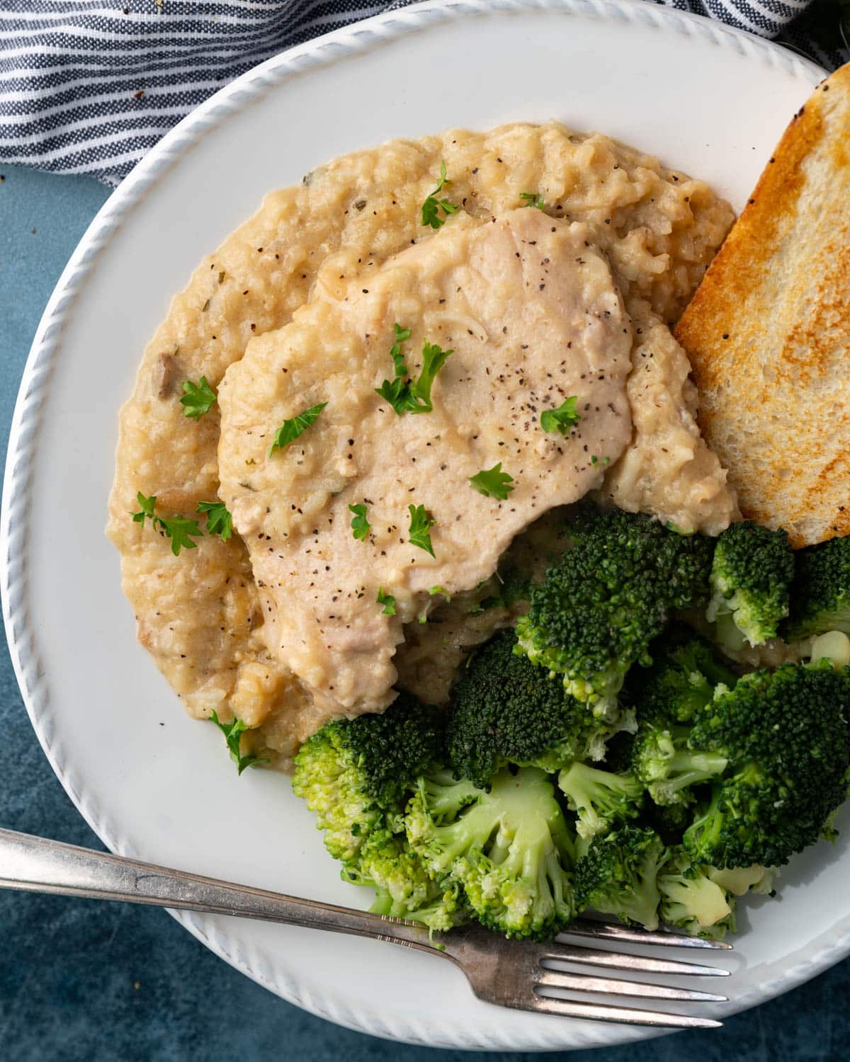 overhead view of a plate of pork chops and rice with broccoli